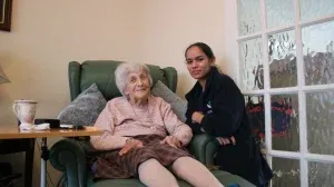 At home care carer giving care from an elderly At Home Care client